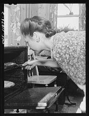 Mrs. Earle Landis taking Thanksgiving pies from the oven