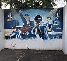 A mural of famous artists wearing a shirt of CE Atlètic Balears on one of the walls of the Camp de Son Malferit.