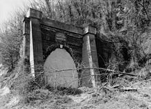 Greenwood Tunnel after abandonment; the concrete buttresses are not original. Northeast Portal of Abandoned Greenwood Tunnel.jpg