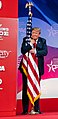 President Donald J. Trump embraces the American flag at CPAC 2019.jpg