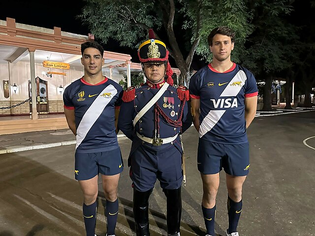 Players of Los Pumas and a grenadier posing with the away uniform for the 2023 World Cup