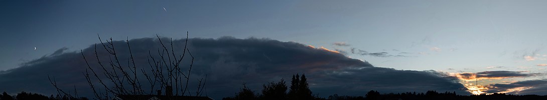 Sun and moon with a cloud bank