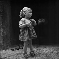 “Children In Naples, Italy”. Little girl along the street. Photographed by Lieutenant Wayne Miller, July 1944. U.S. Navy Photograph, now in the collections of the National Archives.jpg