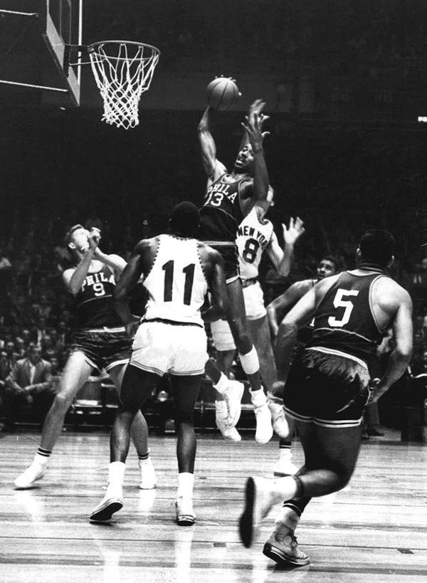 Chamberlain grabbing a rebound during a 1960 game against the New York Knicks