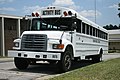 Activity bus at a middle school in Durham, North Carolina. Note the bus is painted white and the roof sign reads Activity Bus.