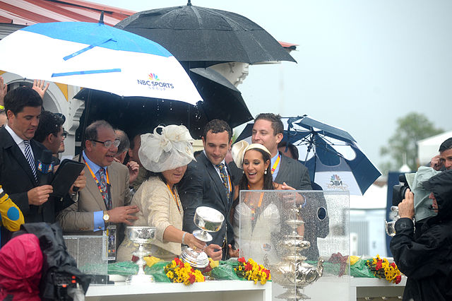 Ahmed Zayat (in beige suit) and family, including son and manager of Zayat Stables racing operations, Justin Zayat (center), at the 2015 Preakness Sta