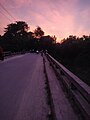 A bridge on top of a lake at early evening in Nawabganj District