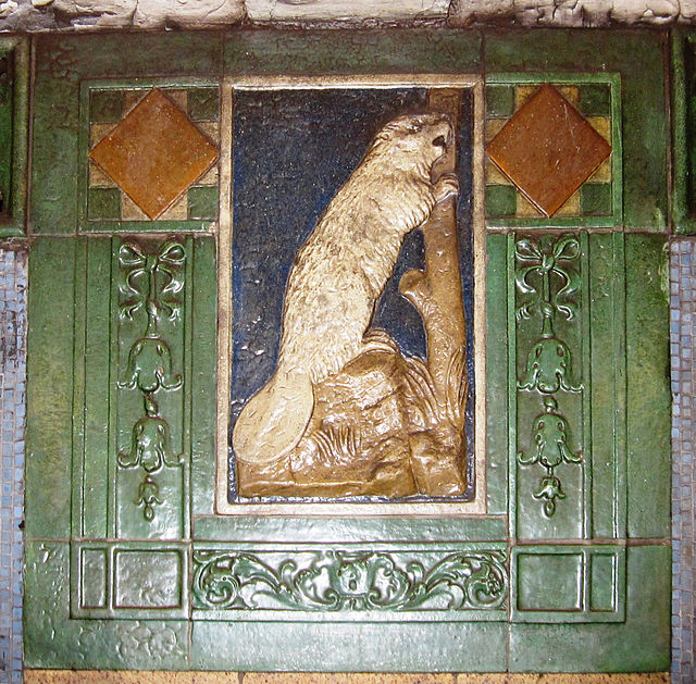 Ceramic plaques on station walls were associated with something of local significance. Seen here is a faience plaque with beaver at Astor Place, repre