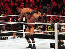 Wade Barrett preparing to perform a fireman's carry slam (Wasteland) on Randy Orton Barrett Wasteland.jpg