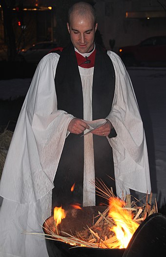 A deacon burning palm fronds from the previous Palm Sunday for Ash Wednesday