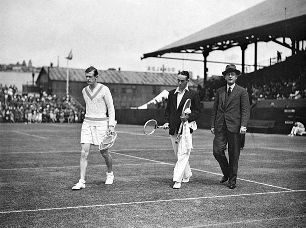 Christian Boussus (left) and Vivian McGrath (center) enter the center court of the White City Stadium in Sydney, Australia in November 1934