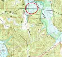 Excerpt of 1991 USGS map with red circle showing approximate former location of Corbin. Note former "Corbin Ch." location in 1940 map now labeled as "Bear Creek Ch.", and Missouri Route 82 has been realigned to the south. The former Route 82 alignment is now NE 320 Rd. through this segment. The road joins modern Route 82 to the east, and ends to the west where the now inundated and wider Weaubleau Creek lies. Corbin Iconium quad 1991 excerpt.png