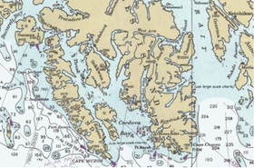 Dall Island ligt ten westen van het zuidelijke deel van Prince of Wales Island en vormt de westkust van Cordova Bay (detailkaart US Coast Survey).