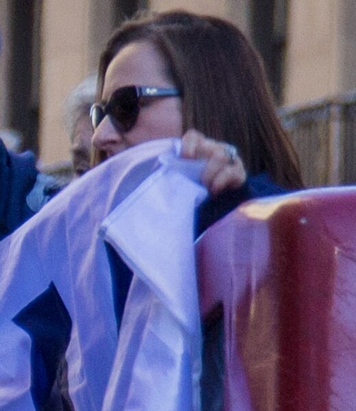 Ricketts holding a Cubs Win Flag during the 2016 World Series victory parade