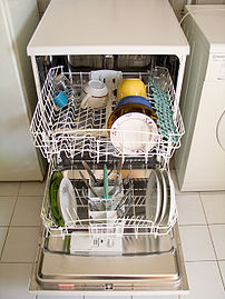 Dishwasher, open and loaded with dishes