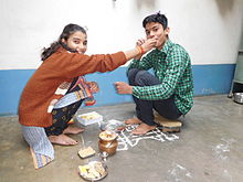 A sister ritually feeding her brother on Bhai Duj-Diwali Diwali (Bhaiya Dweej ).JPG