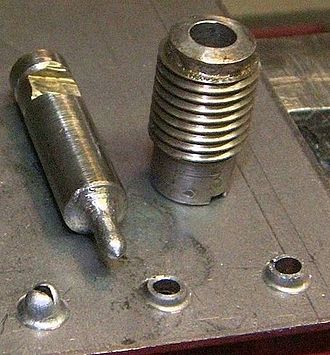 Extruded holes with the punch and die used to create them. No pilot hole was used on the left. Extruded Holes.JPG