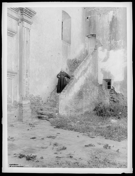 File:Father O'Keefe standing halfway up the brick stairs leading to the choir outside at Mission San Luis Rey de Francia, August 2, 1900 (CHS-596).jpg