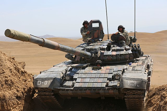 Georgian soldiers, 44th Armored Battalion, drive a T-72 tank into a fighting position during a combined training exercise, Vaziani, Republic of Georgi