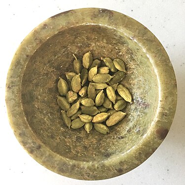 Whole, dried green cardamom pods from Tamil Nadu, India in a bowl.