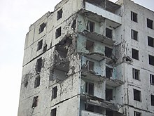 A building damaged during the war in Grozny Grozny - damaged flat building (2006).jpg