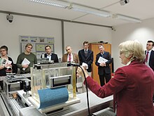 Joanna Izewska gives Ambassador Frank Recker and his delegation a tour of the IAEA Dosimetry Laboratory. IAEA Dosimetry Lab (06010192) (12188087435).jpg