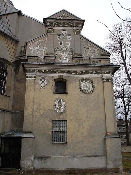  West classical facade of the St. John the Baptist church. It showing the shields with the  Pilica owners of  emblems, a Waga, Korybut, Nawina, Abdank, Róża, Godzięba, Jstrzębiec z Orłem and Skrzyżowane Berła (Akademia Krakowska).