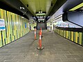 The mid-level concourse with the stairs leading to the forecourt closed off and the stairs opened to the platforms, July 2024