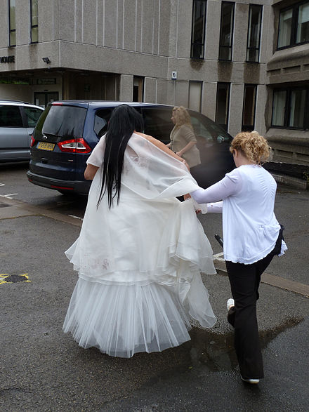 Officers from the UK Border Agency lead away the would-be bride in an operation to prevent a suspected sham marriage.