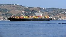 A cargo ship cruises towards the Strait of Messina