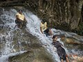 Local swimmers and waterfall at entrance