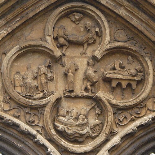 Quatrefoil above the west door of Croyland Abbey showing in relief scenes from the life of Saint Guthlac