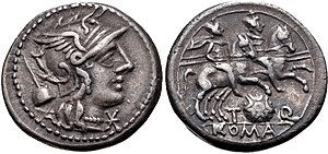 Denarius of Titus Quinctius Flamininus, 126 BC. On the obverse is the head of Roma, with the apex of the Flamen Dialis behind, alluding to his cognomen. The reverse shows the Dioscuri riding right, with a Macedonian shield below, which is a reference to the Battle of Cynoscephalae won by his great-grandfather in 197 BC. T. Quinctius Flamininus, denarius, 126 BC, RRC 267-1.jpg