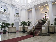 The main staircase in the Presidential Office Building being guarded by Republic of China Military Policeman Taiwan Presidential Building staircase with Military Police Officer guarding.jpg