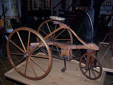 Three spoked wheels on an antique tricycle