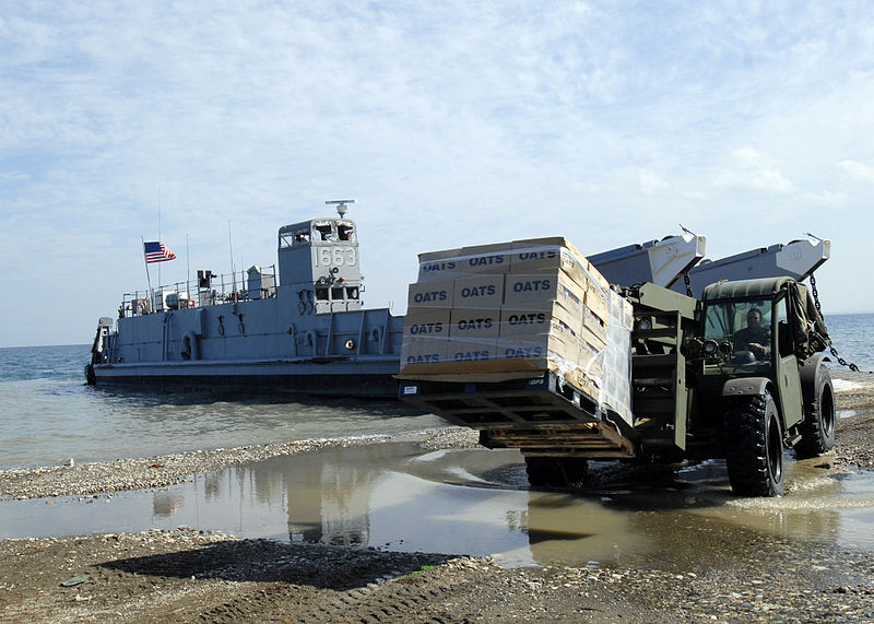 File:US Navy 100213-N-2000D-079 A Seabee assigned to Amphibious Construction Battalion (ACB) 2 delivers humanitarian supplies at a landing site in Grand Goave, Haiti.jpg