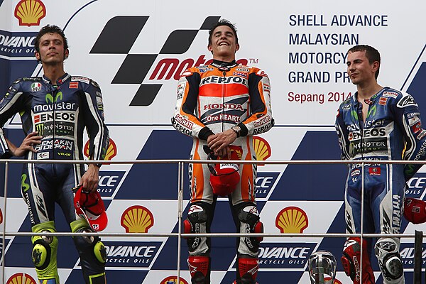 Valentino Rossi, Marc Márquez and Jorge Lorenzo, celebrating on the podium after finishing second, first and third at the MotoGP race