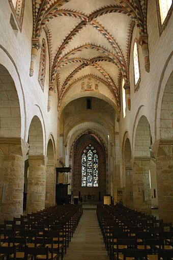 Interior of Romainmôtier Priory church showing the Romanesque massive pillars and groined arches.