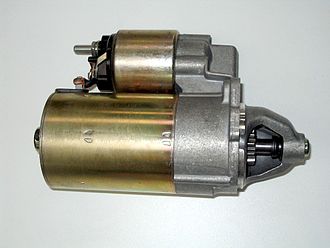 The starter solenoid is above the starter motor. The threaded terminal at left would connect to the battery through a heavy cable. At the right end of the solenoid coil, a linkage inside the housing would engage the pinion visible in the housing at the right side of the motor. Automobile starter.JPG