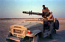 Two Iranian soldiers with a BGM-71 TOW mounted on a Toyota Landcruiser during the Iran-Iraq war.