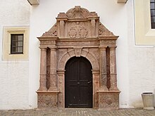 The mannerist portal (rhyolitic tuff) of the church house carved by Andreas Walther II during 1584.