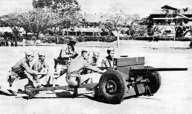 Philippine Scouts at Fort William McKinley firing a 37mm anti-tank gun in training.