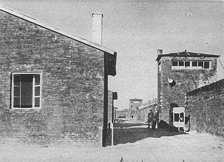 A black-and-white photo of barracks and watchtowers of the Warsaw concentration camp, as photographed by Battalion Zośka on 5 August 1944, the day of its liberation
