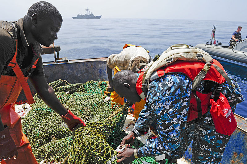 File:Gambian Navy Leading Seaman Sainey Ngum, right, checks the size of the holes of a fishing net on a vessel operating in Gambia's exclusive economic zone off the coast of West Africa June 20, 2012, to ensure it 120620-N-GN377-040.jpg