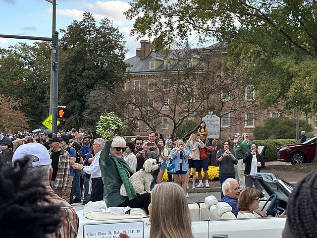 Close (seated with dog) leading the College of William & Mary's 2023 homecoming parade