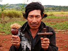 Guarani spiritual leader with ceremonial gourd rattle and cross, 2006 Guarani shaman.JPG