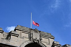 A Red Ensign with the crest of Kingston upon Hull flying half-mast on the Hull Guildhall.