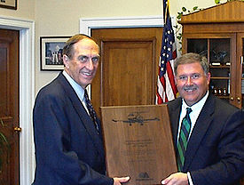 Hefley, left, receives an award from the Director of Centennial Airport. Joel Hefley.jpg