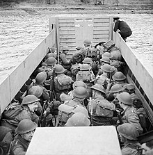 Men of the 6th Battalion, Black Watch crouch down in a landing craft as it approaches the shore, during combined operations training in Scotland, 17 November 1942. Men of 6th Battalion, the Black Watch crouch down in a landing craft as it approaches the shore, during combined operations training in Scotland, 17 November 1942. H25391.jpg