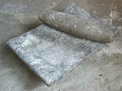 Two items commonly used by indigenous Mexicans. The mortar is called a Metate and the stone lying across it a Mano. It is held in both hands and used to grind corn, cacao and other basic foods. Metate-and-Mano.jpg